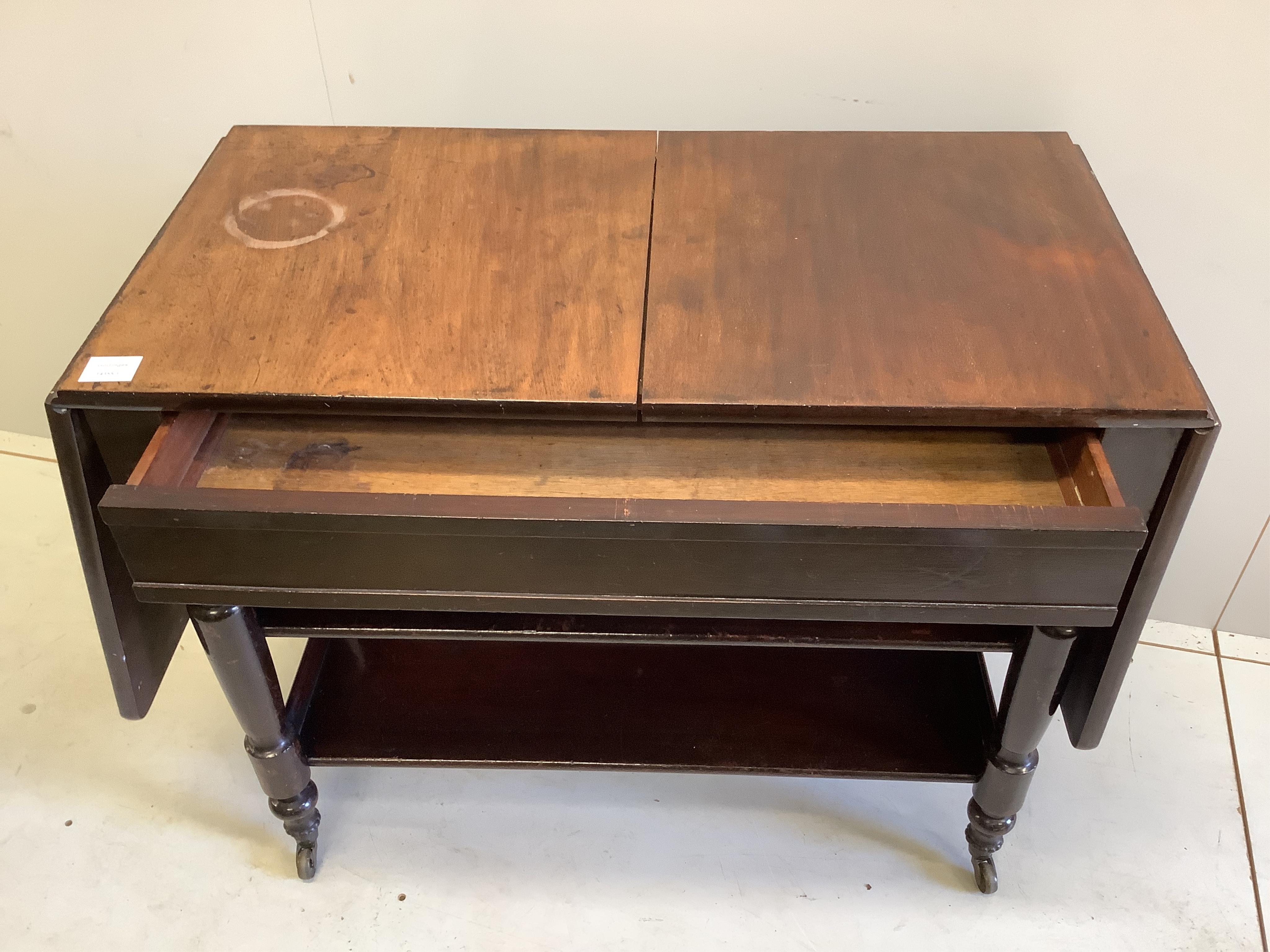 A Victorian mahogany drop flap three tier side table, width 89cm, depth 45cm, height 72cm. Condition - fair